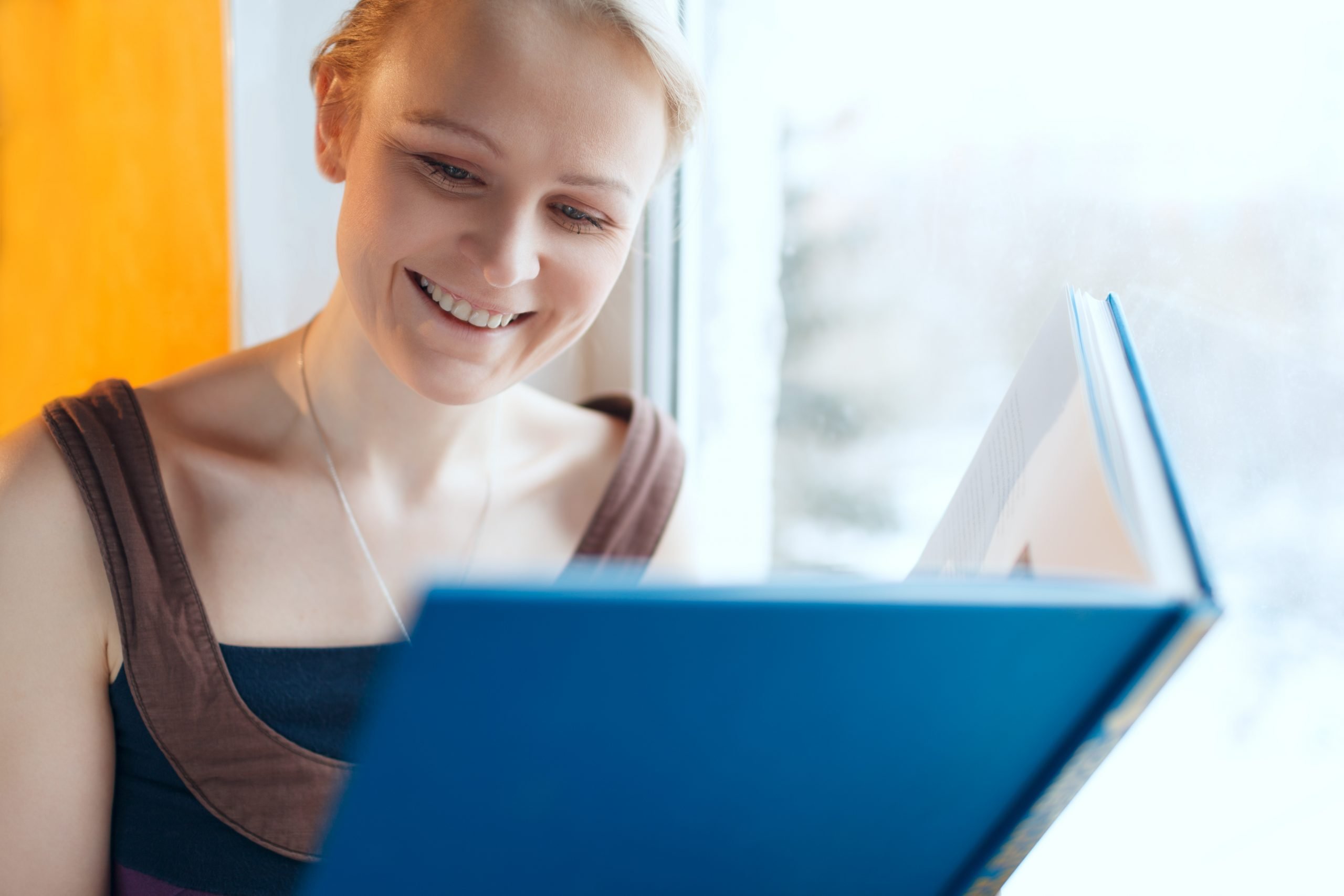 woman smiling looking at a photobook gift