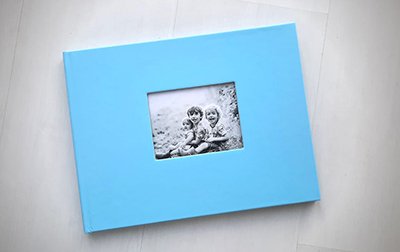 Mothers day photobook gift with pale blue cut out window cover and a picture of three little boys in black and white