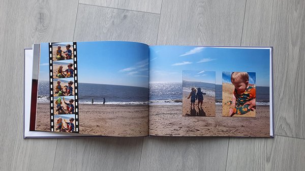 an annual photobook showing a day out on the beach with 3 boys and a template of a film strip